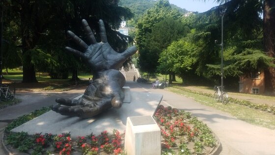 Open hands sculpture in a public park of Como - Italy